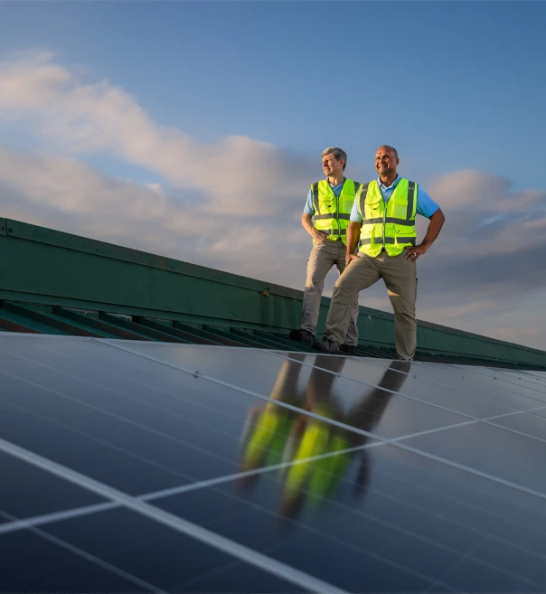 Man on solar oanel roof