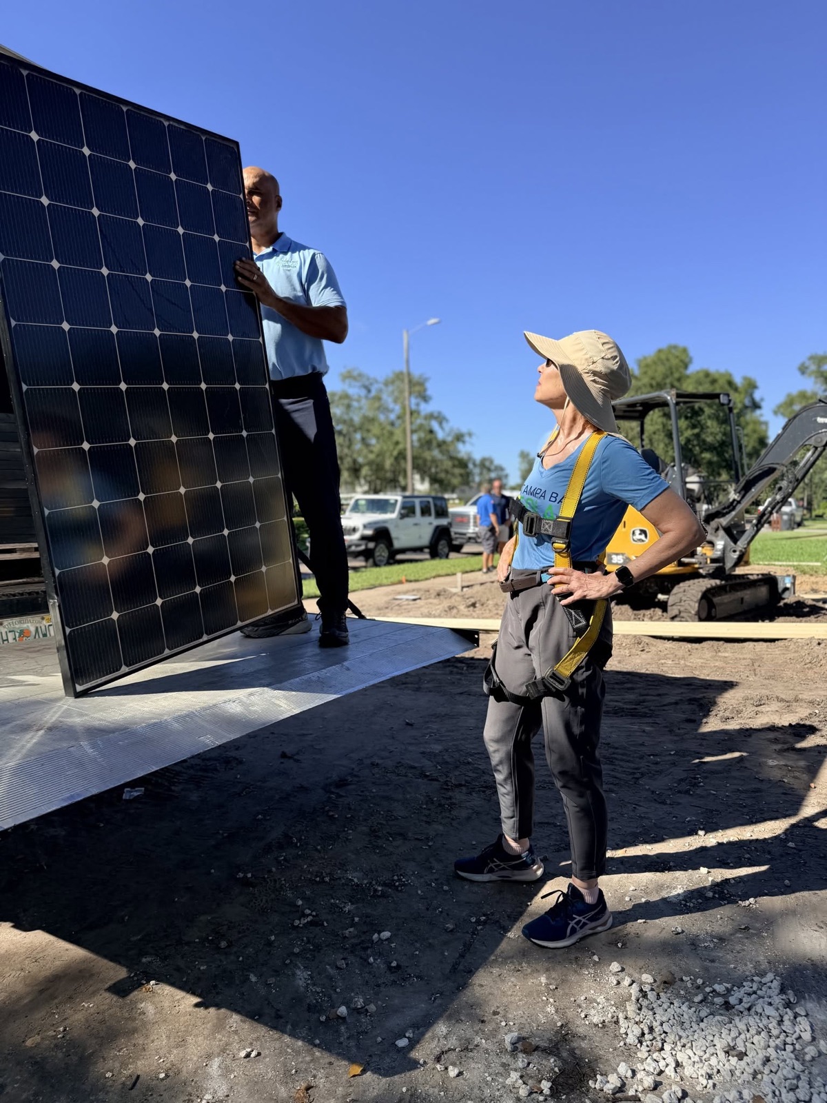 Steve Rutherford shows Congresswoman Gwen Graham a solar panel on a Tampa Bay Solar job site